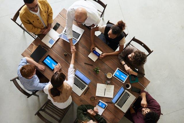 Groep mensen van bovenaf gezien die vergaderen